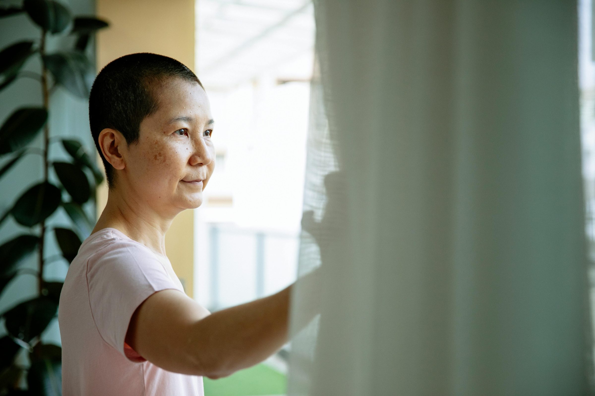 Person standing looking out window