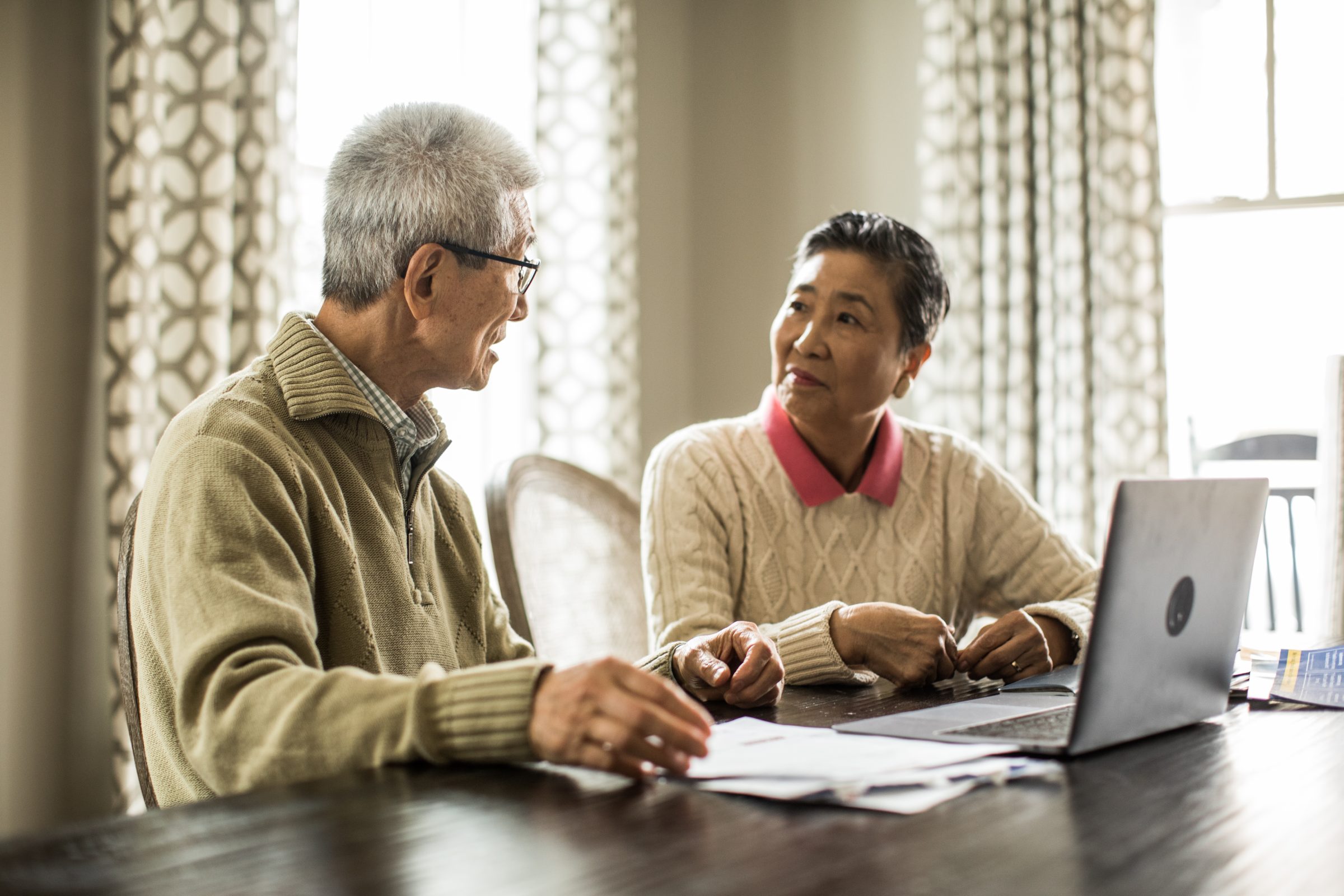 Senior Couple Using Laptop To Pay Bills At Home